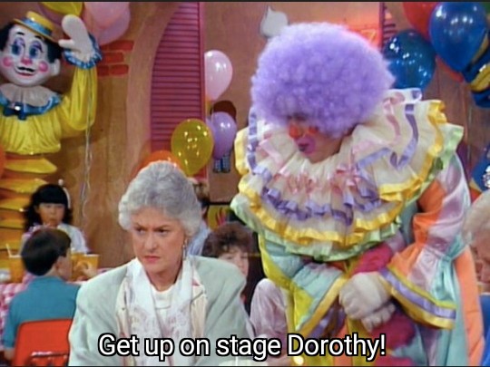 A clown asking Dorothy to get on stage at a birthday party