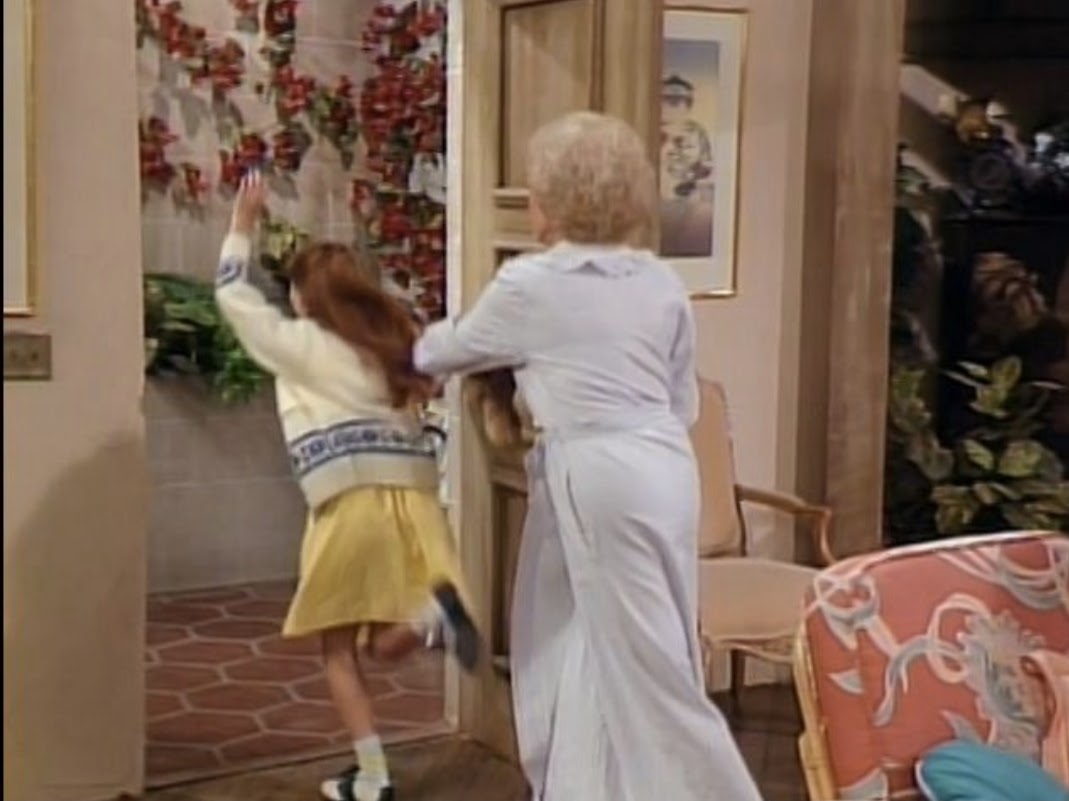 Rose shoving a wee lassie out the door