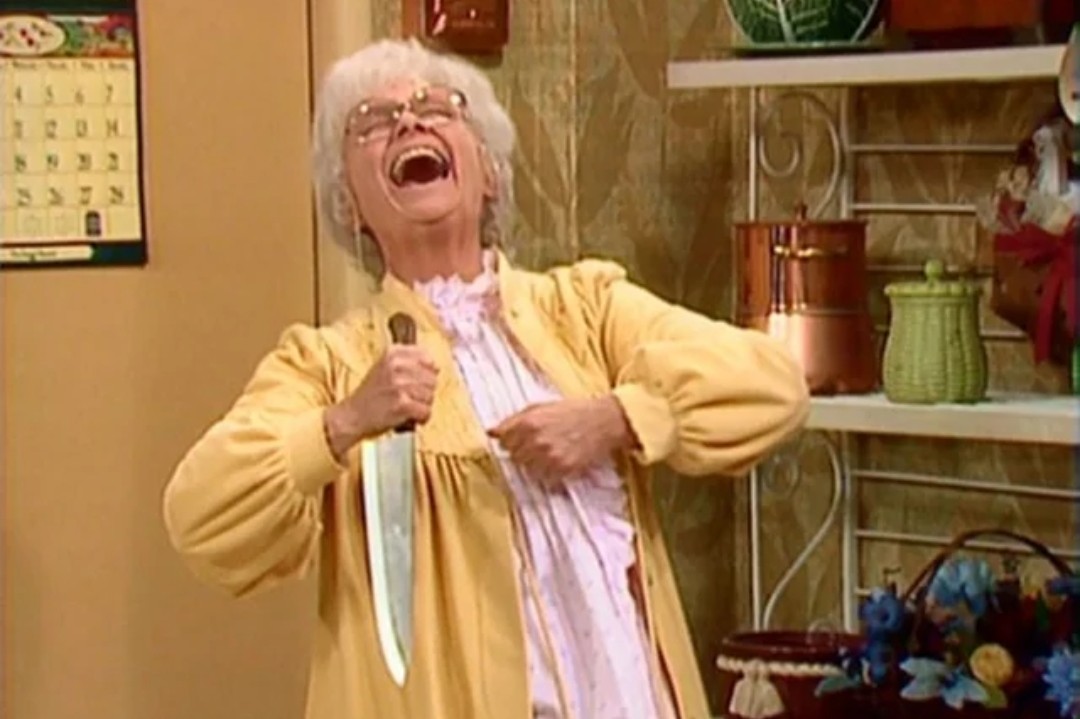 Sophia laughing maniacally while holding a large knife